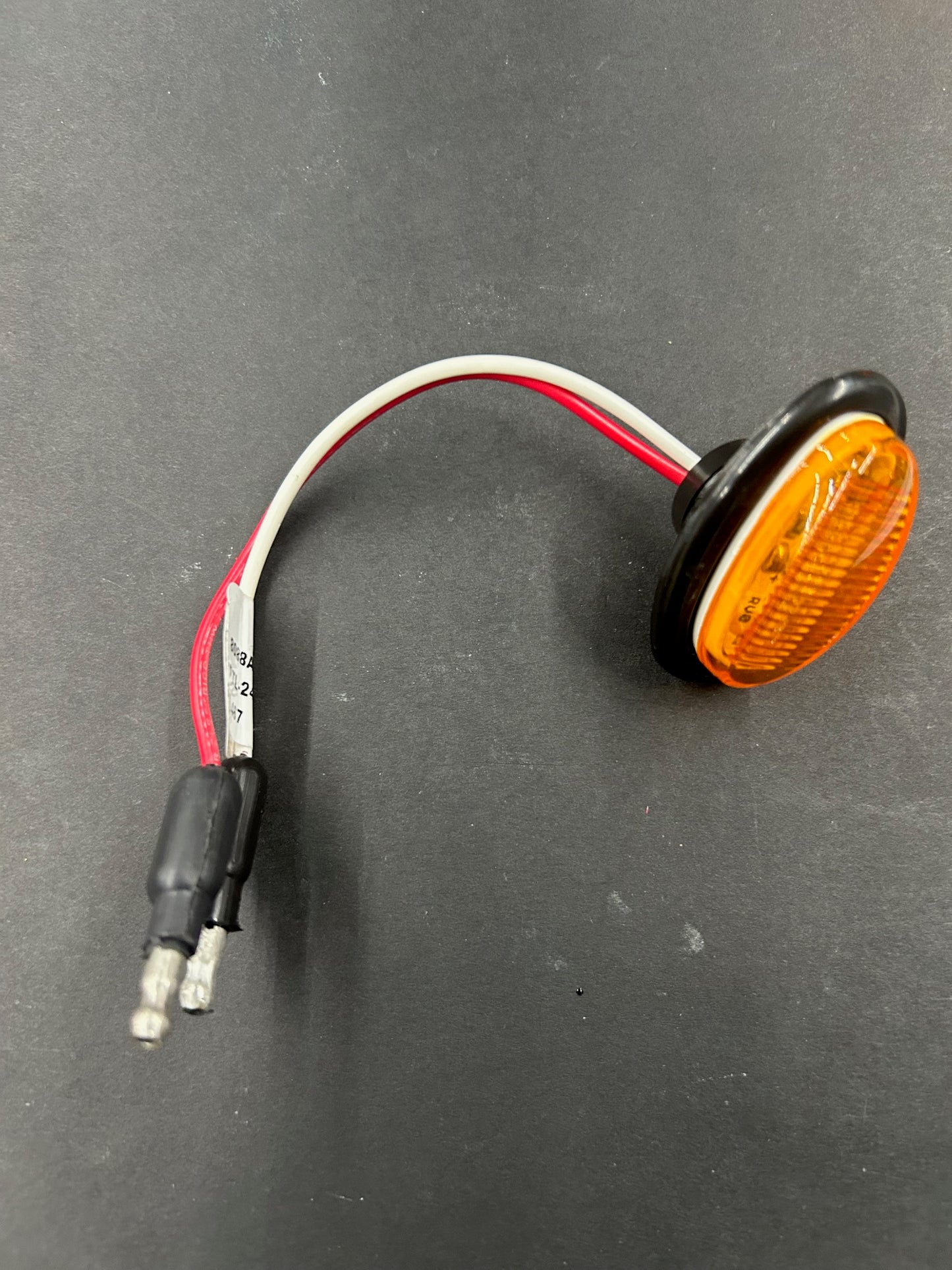 1 1/2 inch oval amber LED marker clearance light with grommet and pigtail for semi-truck 12V and 24V systems.